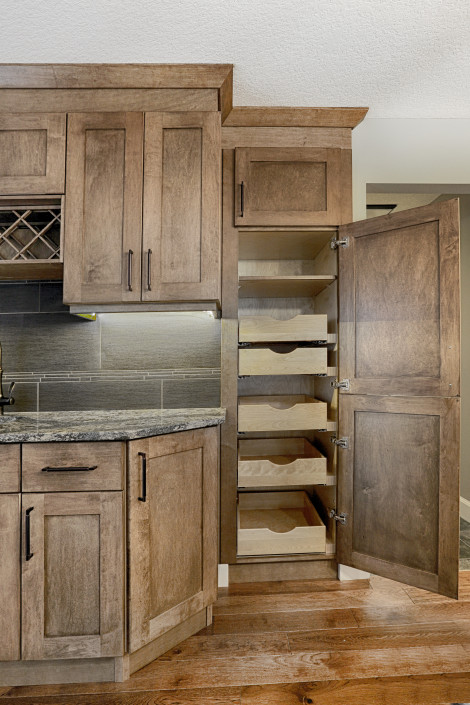 Custom built cabinetry with pull-out pantry. By House of J Interior Design. Edmonton, Alberta.