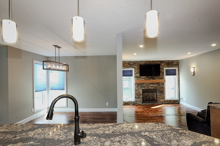 view of the dining area and the family room from the kitchen island. By House of J Interior Design. Edmonton, Alberta.